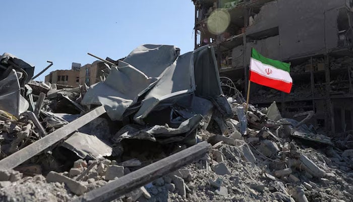 The national flag of Iran flies in the wind as debris lies scattered in the aftermath of an Israeli and US strike on a police station, amid the US-Israeli conflict with Iran, in Tehran, Iran. — Reuters/File
