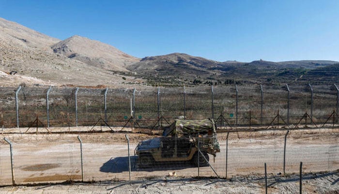 An Israeli army jeep drives in the buffer zone, which separates Israeli and Syrian forces on the Golan Heights, near the Druze village of Majdal Shams in the Israel-annexed Golan Heights on December 14, 2024. — AFP