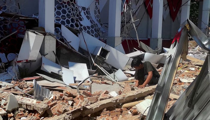 The representational image shows a man inspecting debris at the site of a damaged building following an earthquake in Manado, North Sulawesi province, Indonesia, April 2, 2026. — Reuters