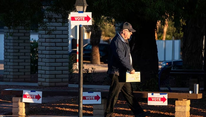 A man walks into a voting centre with his mail-in ballot at Emmanuel Presbyterian Church, on Election Day, in Phoenix, Arizona, US, November 5, 2024. — Reuters