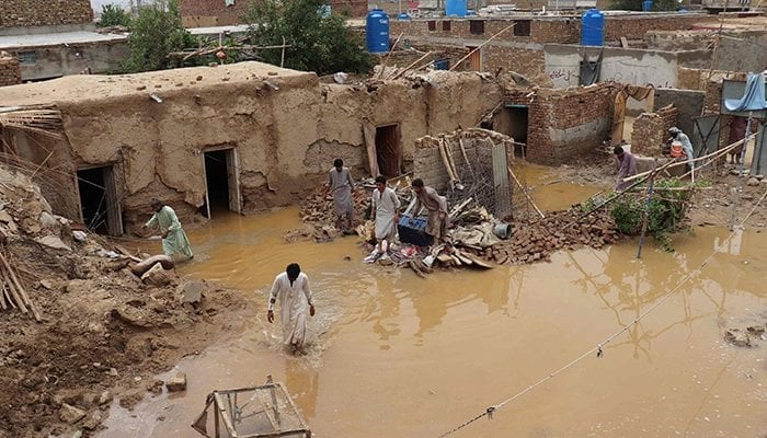 Residents clear debris of a damaged house due to heavy monsoon rainfall on the outskirts of Quetta on July 5, 2022. — AFP