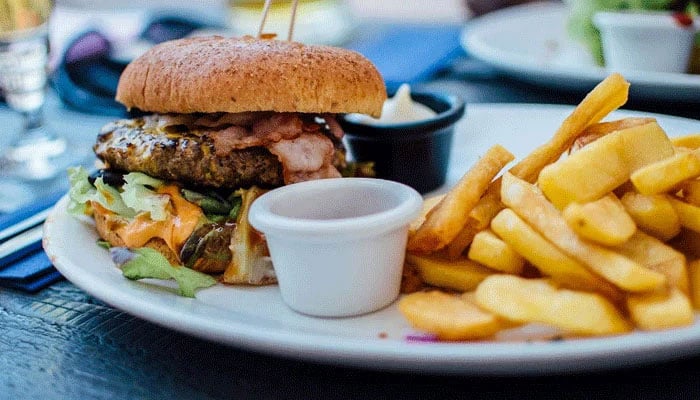 The representational image shows a beef burger and French fries on a plate. — Unsplash/File