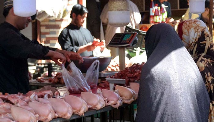 The representational image shows a woman buying chicken in Quetta, on March 1, 2025. — INP