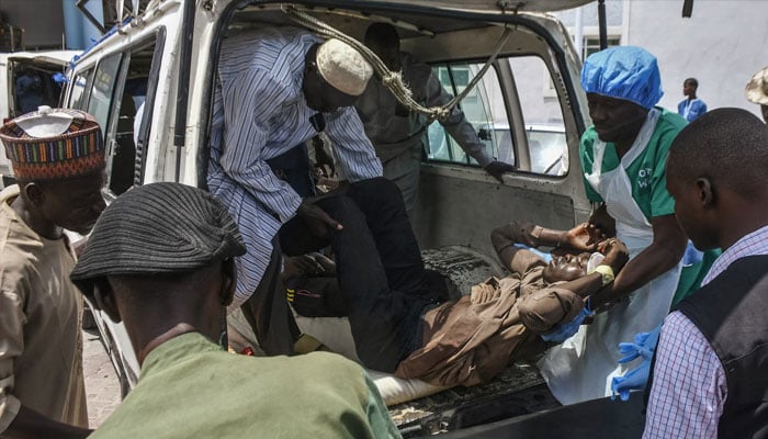 A man injured in one of the attacks arrives for treatment at a hospital in Maiduguri on Saturday.—AFP