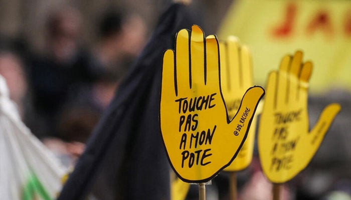 Some protesters hel placards reading Dont touch my mate, the slogan of the anti-racist group SOS Racisme. —AFP