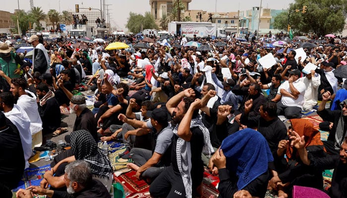 Supporters of Iraqi populist leader Moqtada al-Sadr gather for mass Friday prayer in front of the parliament near the Green Zone, in Baghdad, Iraq August 12, 2022.—Reuters