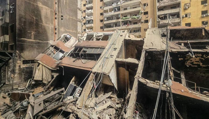 A photograph shows a collapsed building at the site of an overnight Israeli airstrike in the Haret Hreik neighbourhood of Beiruts southern suburbs on April 3, 2026.  —AFP