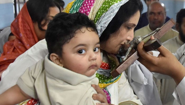 A Christian woman kissing the cross at local church during the ritual of Good Friday, in Lahore on April 3, 2026. — ONLINE