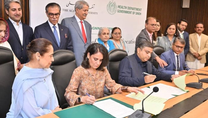 The image shows a signing ceremony of a MoU between the Aga Khan University (AKU) and the Sindh government. — Aga Khan University/File