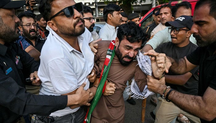 Police personnel detain supporters of the Pakistan Tehreek-e-Insaf (PTI) party as they protest against a fuel price hike in Karachi on April 5, 2026. — AFP