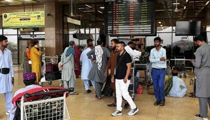 Passengers wait at the Jinnah International Airport after all domestic and international flights were cancelled in Karachi, May 7, 2025. — AFP