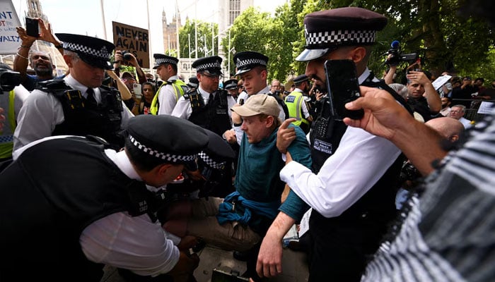 Police officers detain a demonstrator during a rally organised by Defend Our Juries, challenging the British governments proscription of Palestine Action under anti-terrorism laws, in Parliament Square, in London, Britain, August 9, 2025. — Reuters