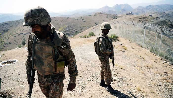 Pakistan Army soldiers patrol next to a newly fenced border fencing along Afghan border at Kitton Orchard Post in North Waziristan. —AFP/File