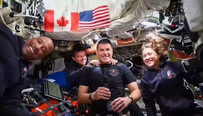 The four astronauts are posing for the photo. —AFP/File