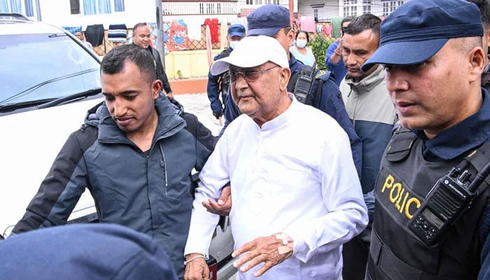 Nepal’s former prime minister KP Sharma Oli is escorted by police as he is brought to the hospital following his arrest in Kathmandu on March 28, 2026. — AFP