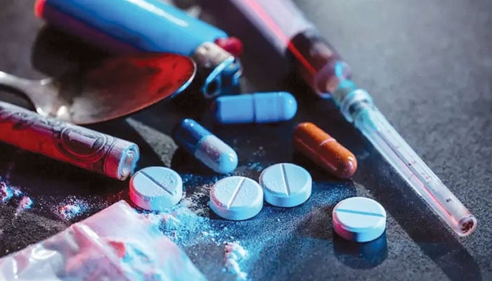 This image depicts illegal substances, including pills, a syringe, a lighter, and a spoon, often associated with substance abuse. — The News/File