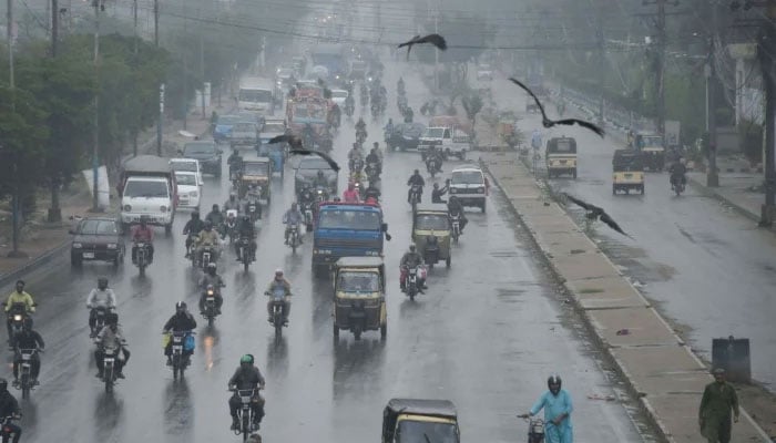 Commuters are passing through a road during the downpour of monsoon in Karachi on August 23, 2025. — Online