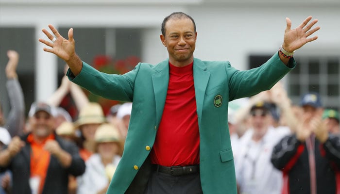 Tiger Woods smiles after being awarded the green jacket following his victory at the 2019 Masters. —AFP/File