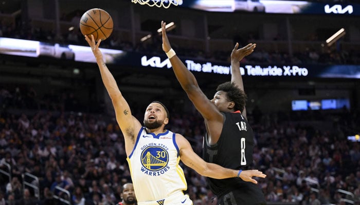 Golden State star Stephen Curry puts up a shot against JaeSean Tate in the Warriors NBA loss to the Houston Rockets, Currys first game. —AFP/File