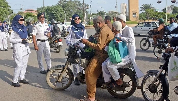 This representational image shows Karachi traffic police personnel speak to a man during an awareness campaign in Karachi, on September 20, 2025. — Online
