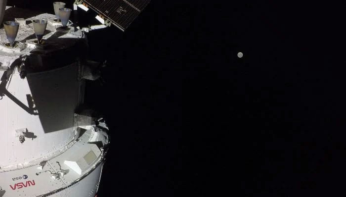 This handout picture provided by Nasa shows the Orion spacecraft with the Moon in the distance, as captured by a camera on the tip of one of its solar array wings, on April 3, 2026. — AFP