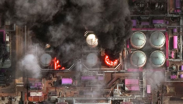 A satellite near-infrared image shows smoke rising from oil storage tanks at Russias Baltic Sea port of Ust-Luga, which was struck multiple times in Ukrainian attacks, in Ust-Luga, Russia March 29, 2026.—Reuters