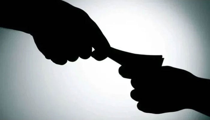 The representational image shows money being delivered as bribery. — AFP/File