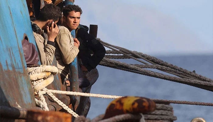 Migrants stand onboard a fishing boat at the port of Paleochora, following a rescue operation off the island of Crete, Greece, November 22, 2022. — Reuters