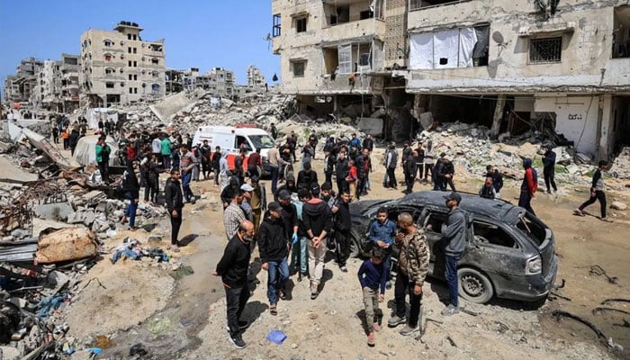 Palestinians inspect the damage after a person was hit by an Israeli strike while riding a bicycle, according to medics, in Gaza City, April 6, 2026. —Reuters