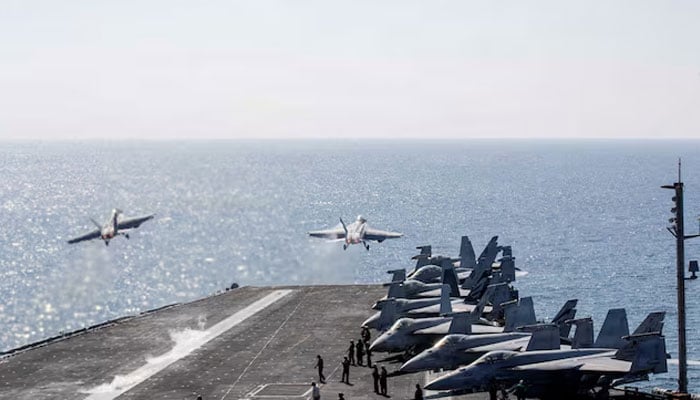Two F/A-18 Super Hornets launch from the flight deck of the U.S. Navy Nimitz-class aircraft carrier USS Abraham Lincoln in support of the Operation Epic Fury attack on Iran from an undisclosed location, March 3, 2026.—Reuters