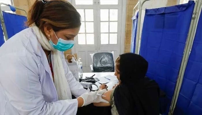 The representational image shows a healthcare professional in Pakistan checking a patient. — Reuters/File