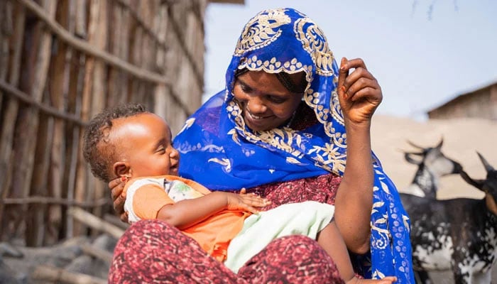In this picture, a mother holding her child in her arms can be seen on November 28, 2023. —Facebook/United Nations Development Programme — UNDP