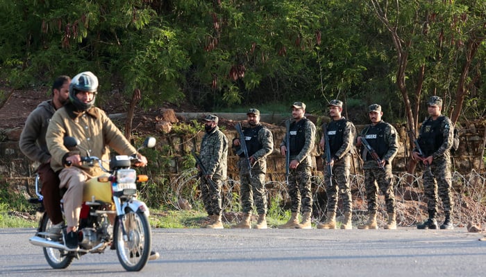 A man rides a motorcycle past Pakistani Rangers standing guard and securing the Red Zone area, as Pakistan prepares to host the U.S. and Iran for peace talks, in Islamabad, Pakistan, April 10, 2026.— Reuters