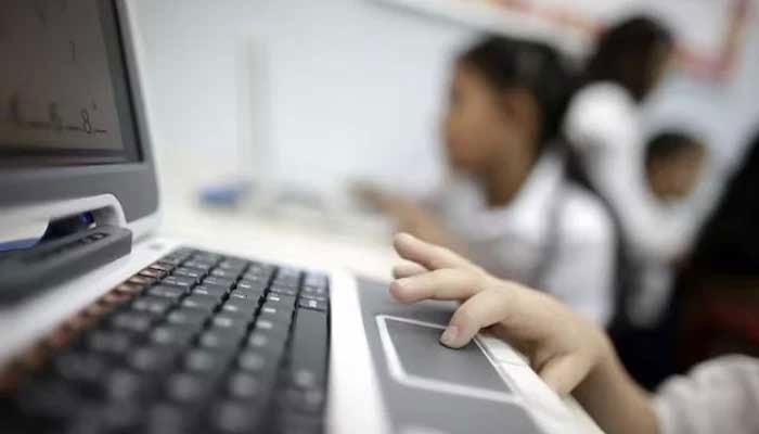 A child uses a laptop in school in this undated photo. — Reuters/File