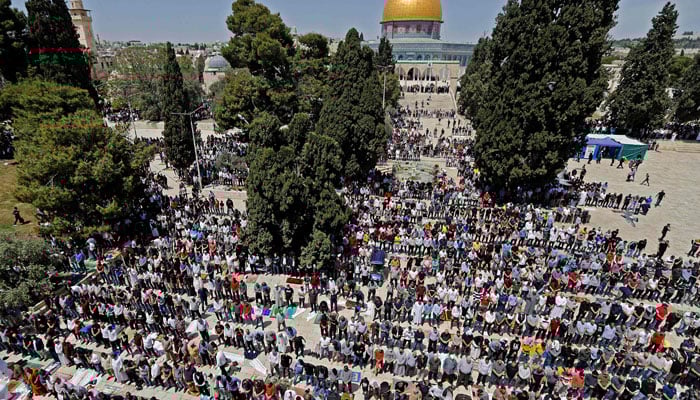 Palestinians take part in the first Friday prayers of the Muslim fasting month of Ramadan, outside the Dome of the Rock at the Al-Aqsa Mosque compound, Islams third holiest site, in Jerusalems Old City, on April 16, 2021. — AFP