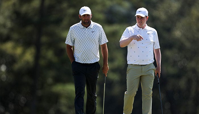(L-R) Scottie Scheffler of the United States and Robert MacIntyre of Scotland look on from the 18th green during the second round of the 2026 Masters Tournament at Augusta National Golf Club on April 10, 2026 in Augusta, Georgia. — AFP