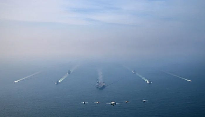 The US Navys Nimitz-class aircraft carrier USS Abraham Lincoln leads its strike group during a photo exercise in the Arabian Sea, February 6, 2026. — Reuters