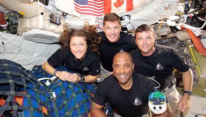 The NASA Artemis II crew, Mission Specialist Christina Koch, Mission Specialist Jeremy Hansen, Commander Reid Wiseman, and Pilot Victor Glover, pose for a group photo inside the Orion spacecraft on their way home following a flyby of the far side of the Moon on April 6, 2026. — Reuters
