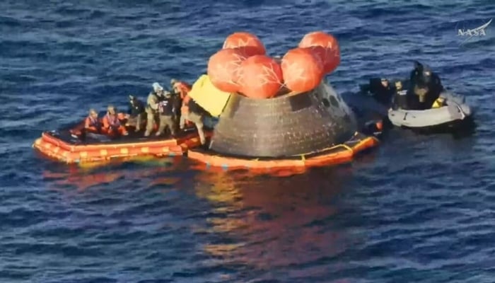 This video grab made from a NASA livestream shows Artemis II crewmembers (in orange suits) being extracted from their spacecraft after splashing down in the Pacific Ocean off the coast of San Diego, California. —AFP