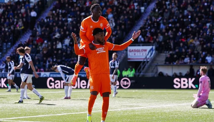 Youssef Chermiti of Rangers celebrates scoring his teams fifth goal with teammate Djeidi Gassama. — AFP/File