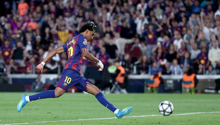 Barcelona’s Spanish forward #10 Lamine Yamal scores his team’s third goal during the Spanish league football match between FC Barcelona and RCD Espanyol at the Camp Nou stadium in Barcelona on April 11 , 2026. — AFP
