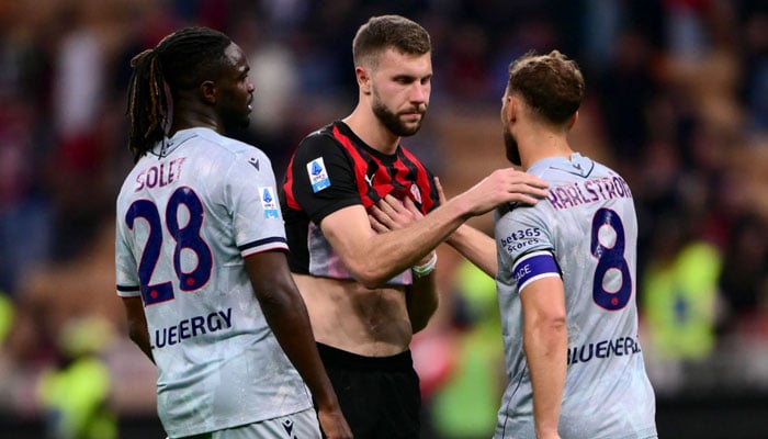 AC Milan’s Serbian defender #31 Strahinja Pavlovic (centre) embraces Udinese’s Swedish midfielder #08 Jesper Karlstrom (right) at the end of the Italian Serie A football match between AC Milan and Udinese at the San Siro Stadium in Milan, northern Italy, on April 11, 2026. — AFP