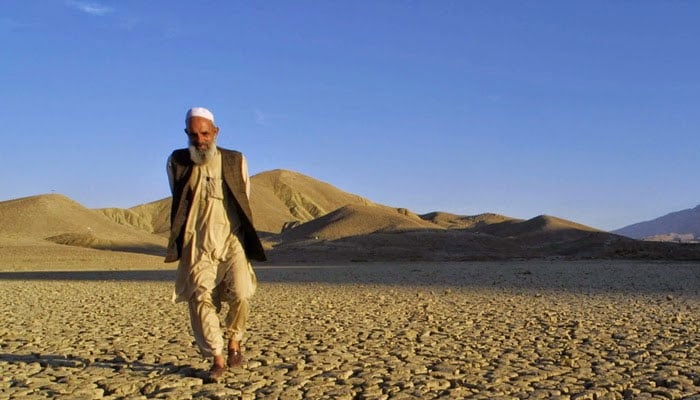 This representational image shows a man walks on the dried, cracked landscape near Hanna Lake near Quetta, Pakistan. — AFP/File