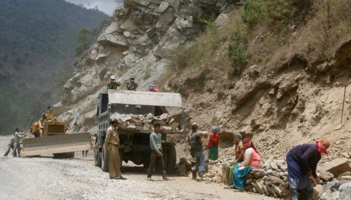 Labourers work on Indias Tezpur-Tawang highway which runs to the Chinese border in the northeastern Indian state of Arunachal Pradesh. May 28, 2012.—Reuters
