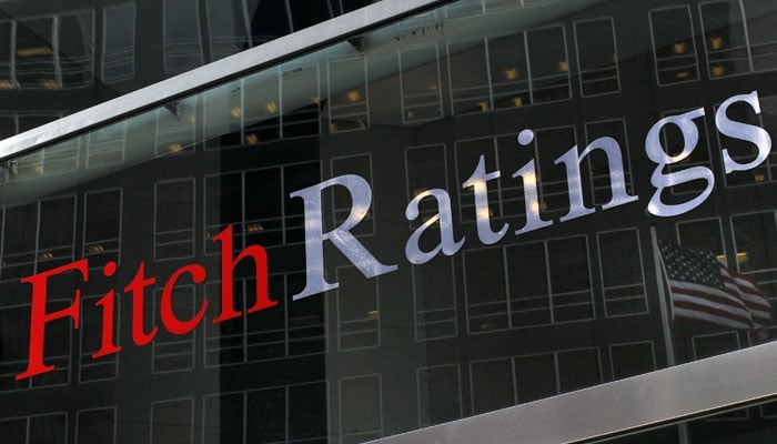 A US flag is reflected on the window of the Fitch Ratings headquarters in New York. — Reuters/File