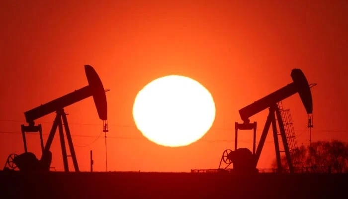 The sun sets behind oil pumps outside Vaudoy-en-Brie, near Paris, France, March 18, 2026. — Reuters