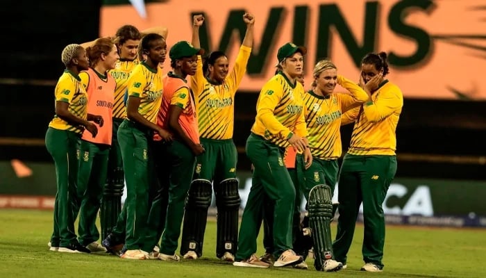 Mignon du Preez and Dane van Niekerk lead South Africa’s celebrations after defeating England in the ICC Women’s T20 World Cup match in Perth on February 23, 2020. – AFP