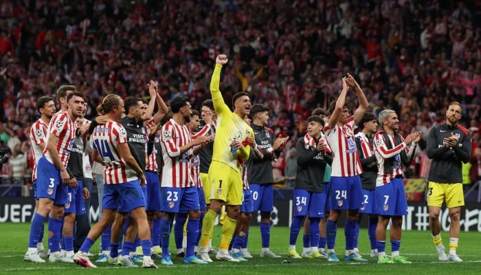 Atletico Madrid players celebrate after the match. —Reuters