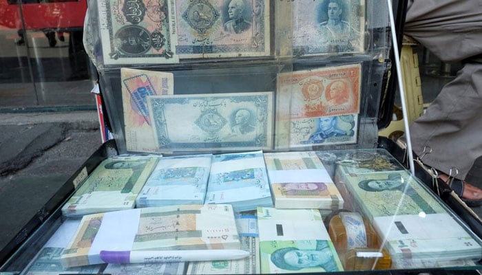 A man displays the Iranian currency at Ferdowsi square in Tehran, Iran July 2, 2020.