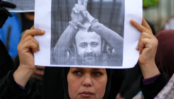 People protest for Marwan Barghouti and other prisoners in the Bureij refugee camp, central Gaza Strip, on 4 April, 2026. —AFP